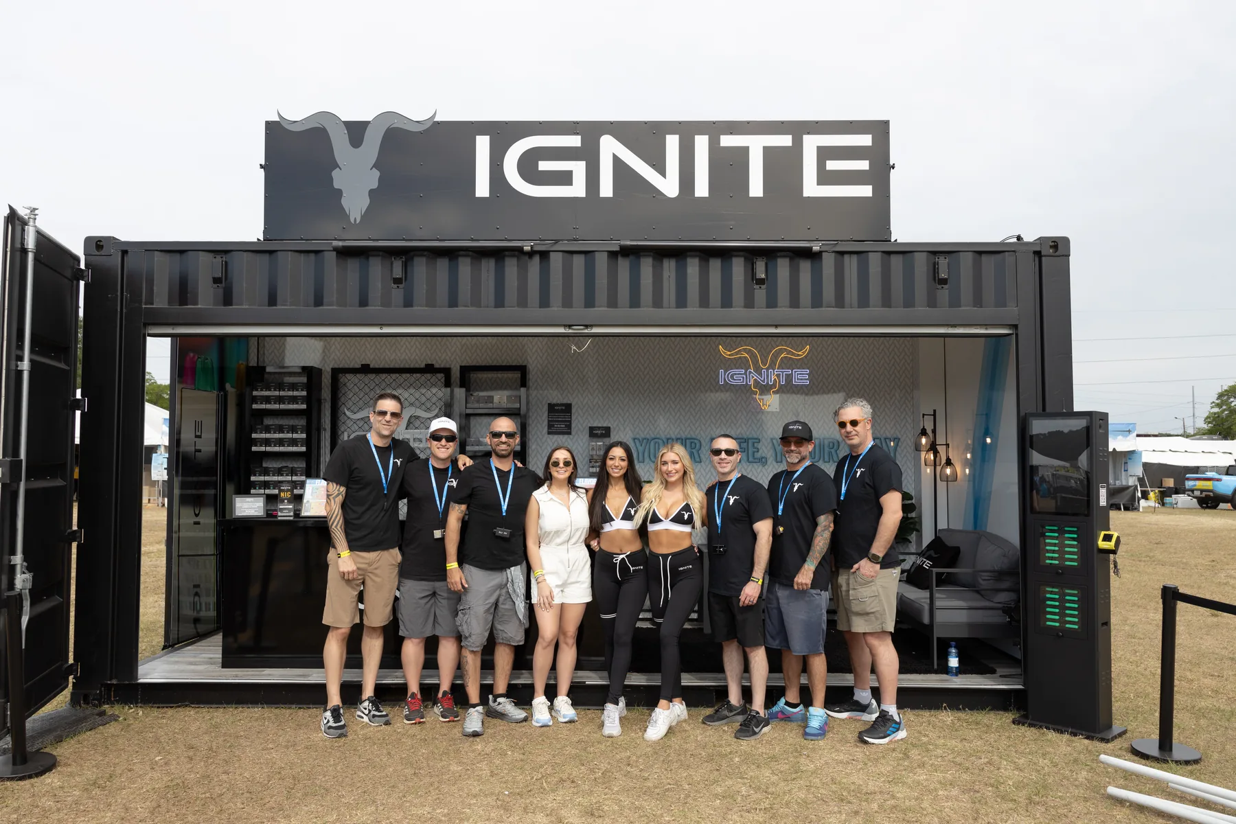 IGNITE team in black shirts in front of the open stand container