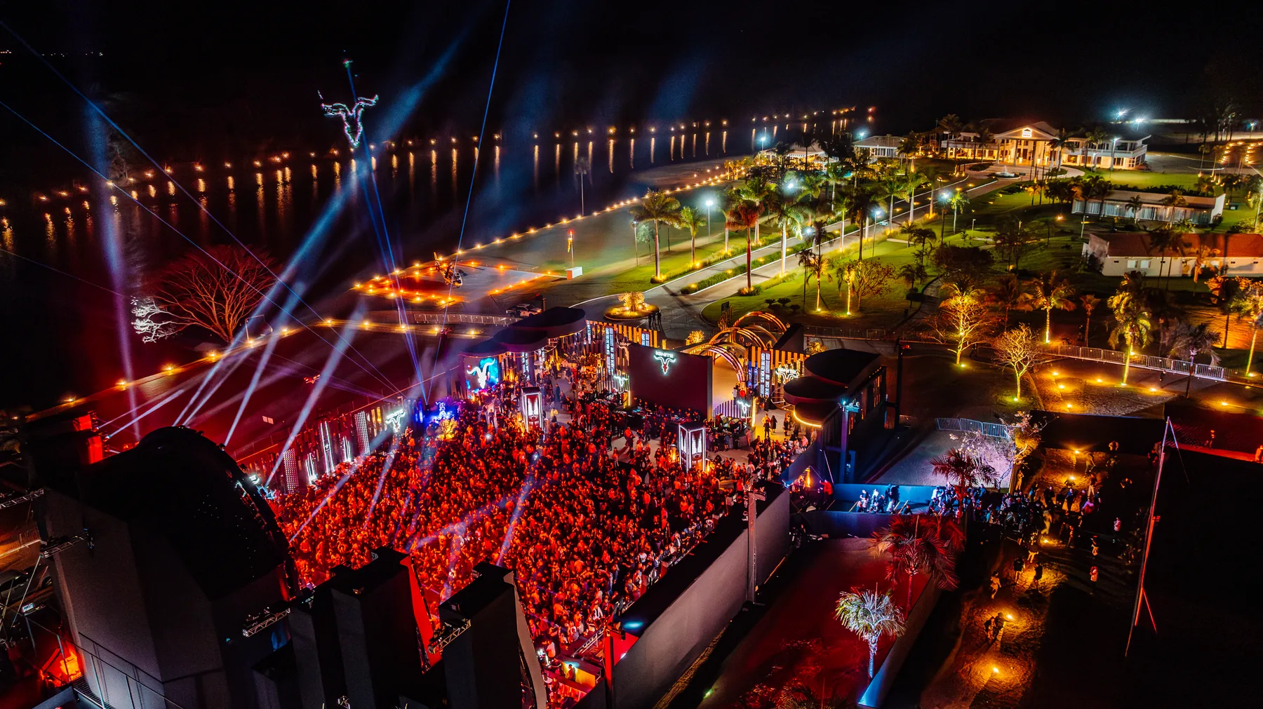 Aerial view of an IGNITE event at night with stage, lasers and audience